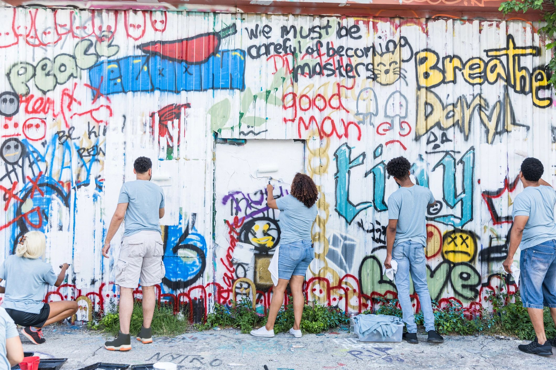Creative group working together on a colorful urban wall