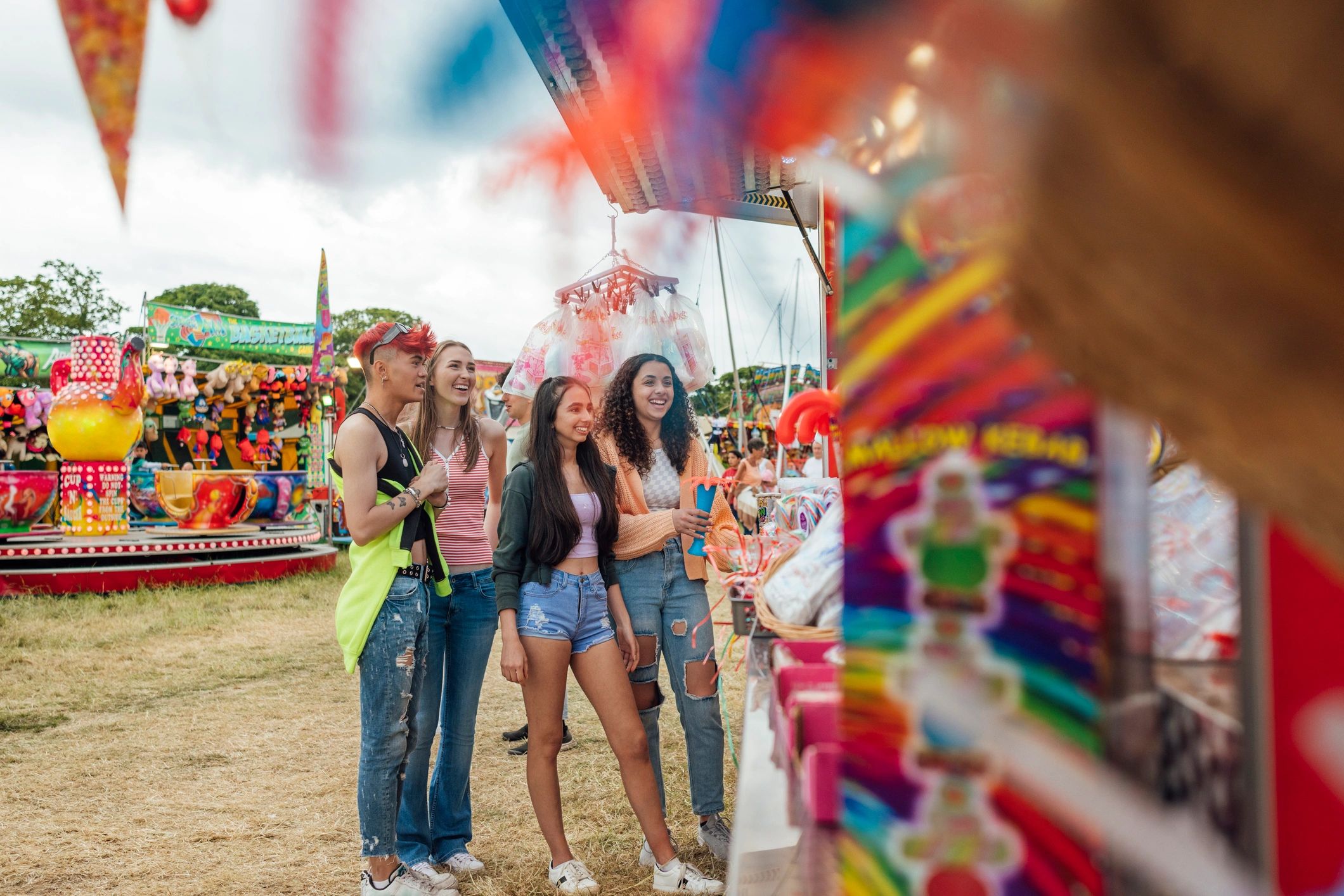 Shoppers browsing food and vendor stalls at a lively market