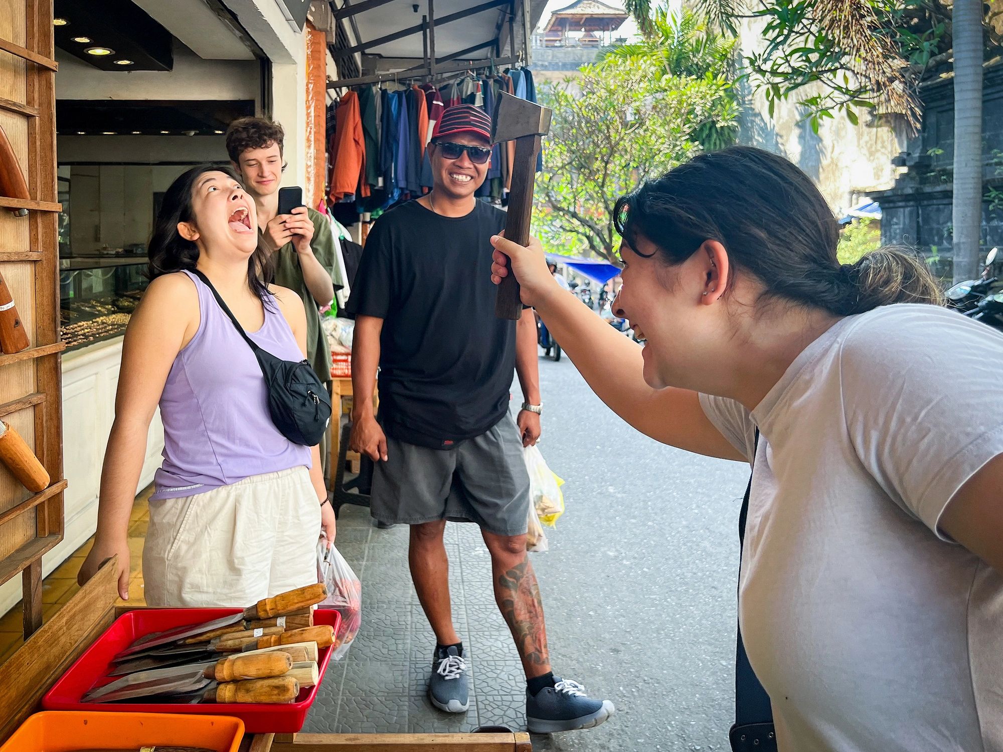 Visitors enjoying a playful moment at a market vendor stall