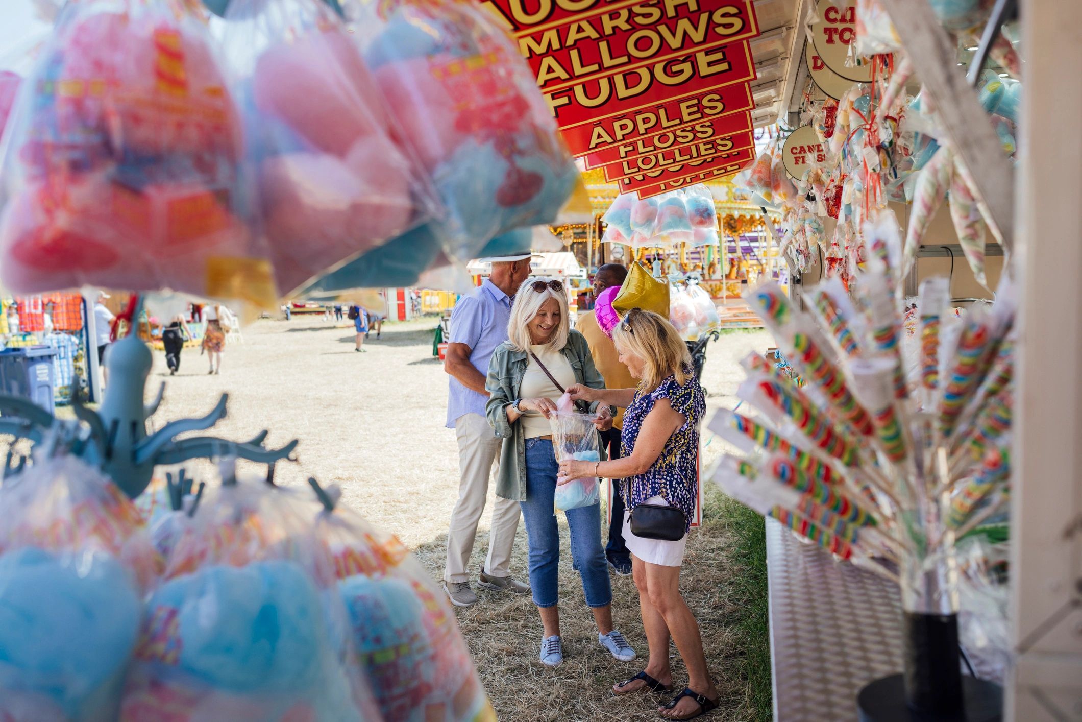 Guests visiting food and retail stalls at a fair-style market