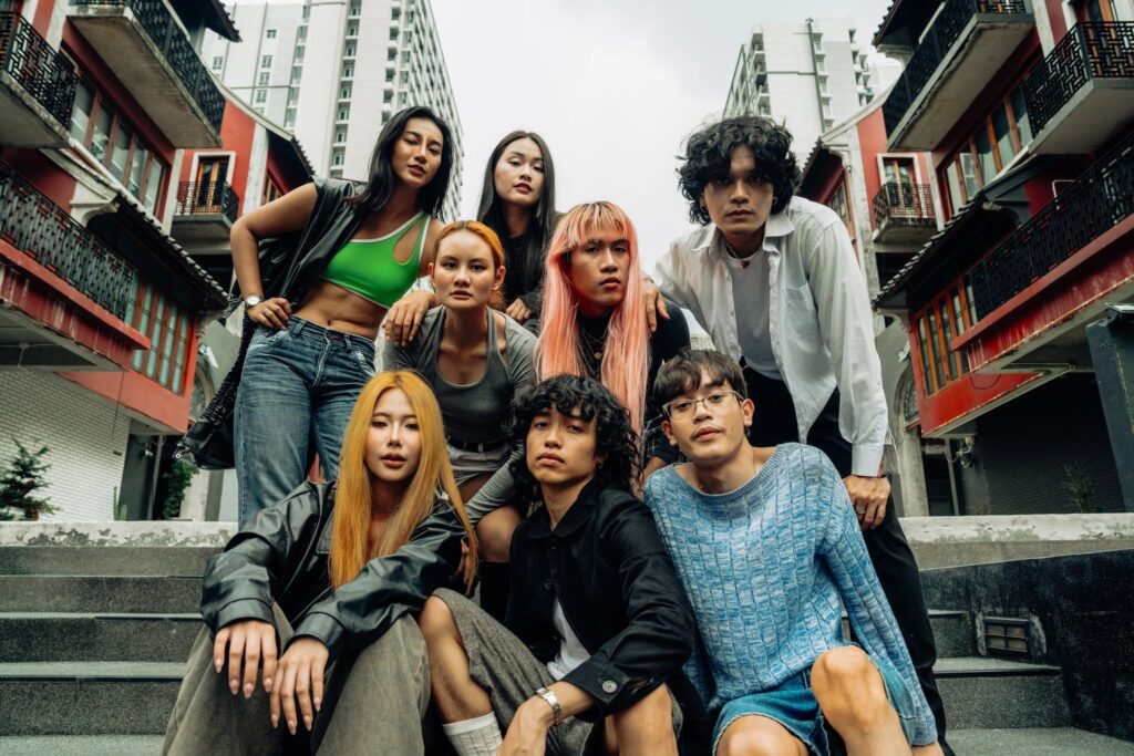 Stylish young adults gathered for a group portrait, exuding individuality and confidence in a contemporary urban setting. Ideal for themes of friendship and city life.